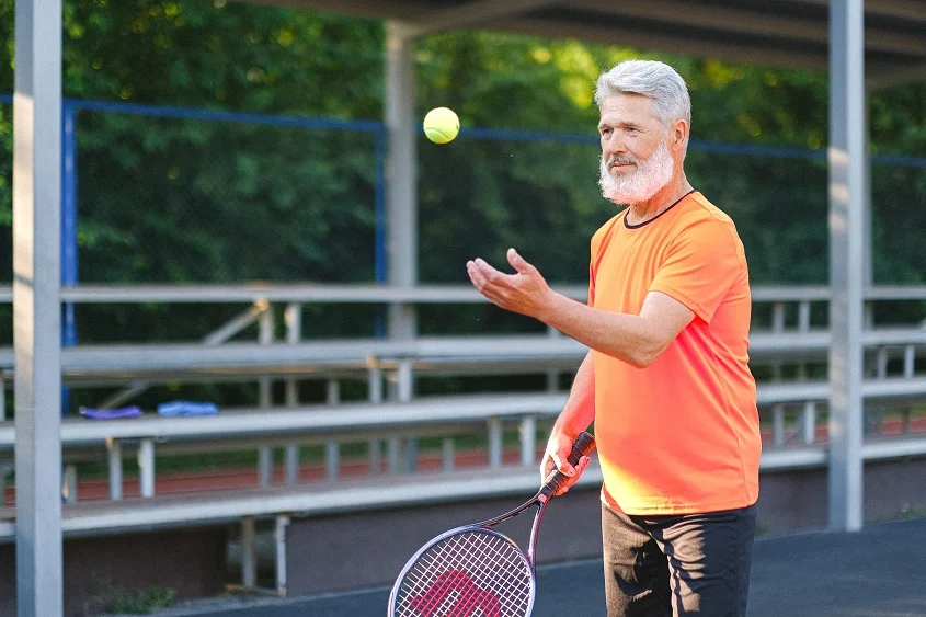 A person with a beard and a tennis racket